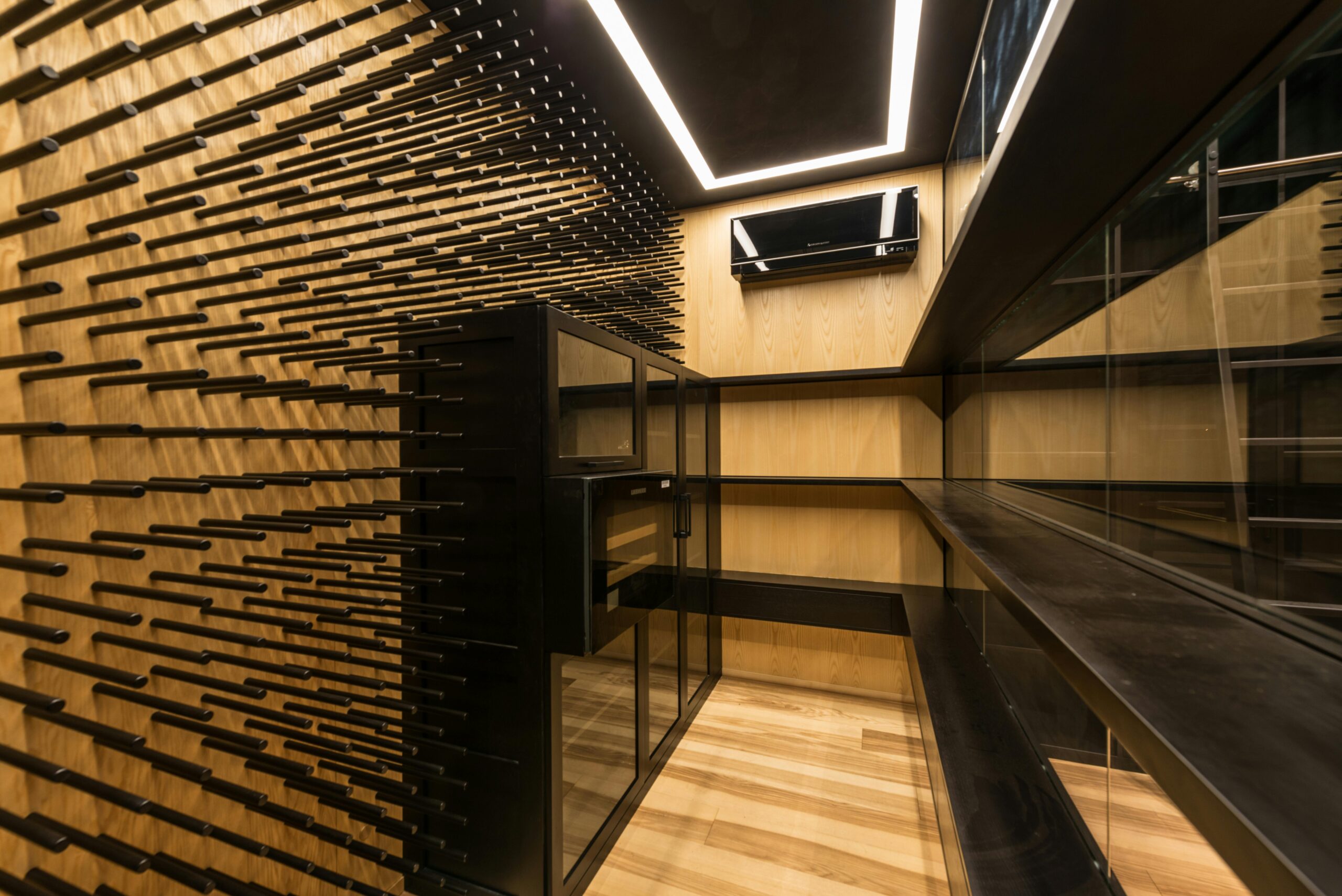 Custom basement wine cellar with custom dowels and hardwood floors