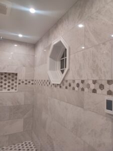 Modern standing shower bathroom remodel by Visionary Custom Creations featuring dual vanity, custom tile walls and floors, and a luxury shower in Bucks County, Pennsylvania.