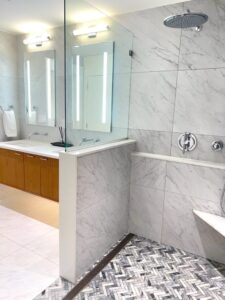 Modern bathroom remodel by Visionary Custom Creations featuring dual vanity, custom tile walls and floors, and a luxury shower in New Hope, Pennsylvania.