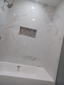 Modern bathtub and shower remodel by Visionary Custom Creations featuring a newly installed bathtub, custom tile walls and floors, and luxury finishes in Bucks County, Pennsylvania.
