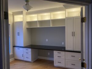 Custom built-in home office with wall-mounted desk, shelving, and integrated lighting in a luxury Bucks County, Pennsylvania remodel