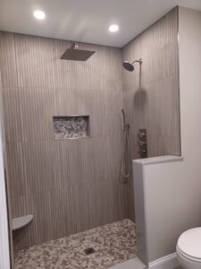 Modern rain shower bathroom remodel by Visionary Custom Creations featuring dual vanity, custom tile walls and floors, and a luxury rain shower in Bucks County, Pennsylvania.