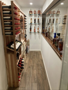 Custom Home Wine Bar in Furlong, Pennsylvania with Wood Counters and Glass Shelving